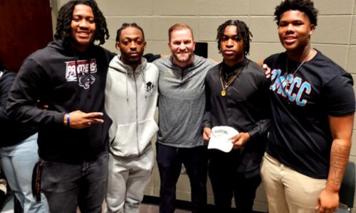 Oxford football signees (from left) Desmond Whitson, D.K. Wilson, Cedric Twyman and Markevion Conley pose for a picture with Oxford coach Sam Adams during Thursday’s ceremony to celebrate their college signings … Wilson and Twyman with Harding University, Whitson with Clark-Atlanta University and Conley with Mississippi Community Christian College. (Photo by Joe Medley/East Alabama Sports Today)